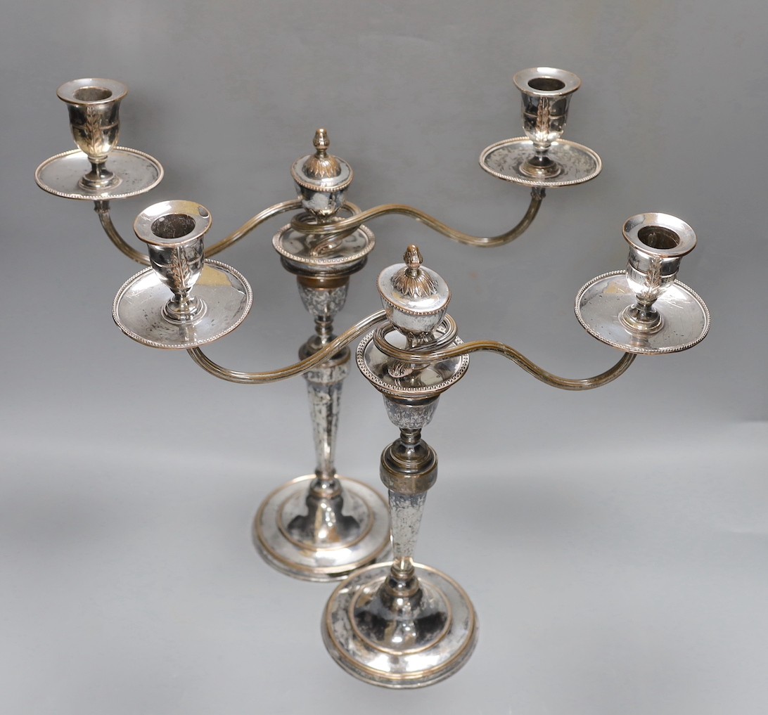 A pair of Sheffield plate two-branch twin-light candelabra, 37 cms high.